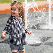 Toddler playing near a fountain